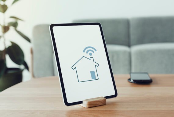 Digital tablet screen with smart home controller on a wooden table