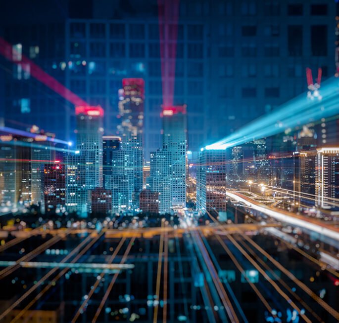 Light trails above buildings at night in China.